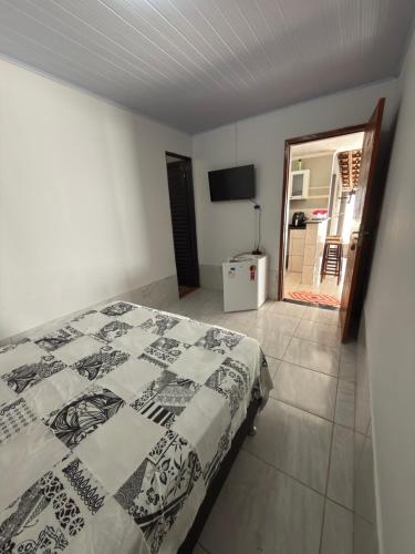 ein Schlafzimmer mit einem Bett und Blick auf ein Badezimmer in der Unterkunft Quarto casal in Trindade