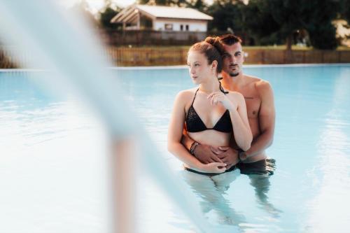 a man and a woman standing in a swimming pool at Na Kameni in Vsetín