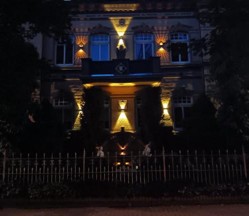 a house with lights on the front of it at night at Comic Fantasy & Cosplay - Leipzig-Halle - Messe, 4 Betten, Parkplätze, echte Kamine in Delitzsch