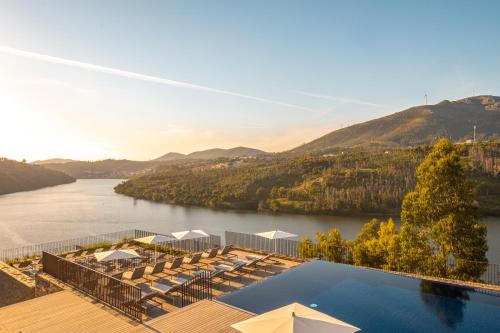 a resort with a pool and a view of a river at Octant Douro in Castelo de Paiva