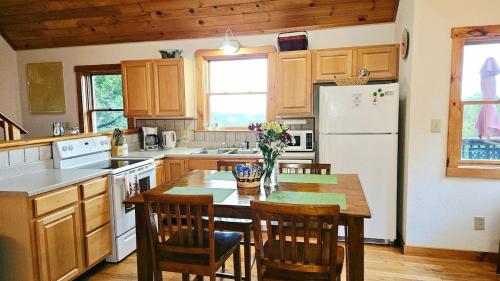 a kitchen with a table and chairs and a refrigerator at Chapel Rest - Breathtaking Views in Boone