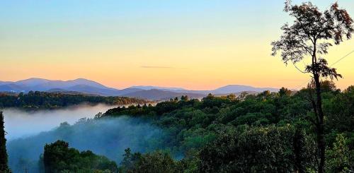 a view of a foggy valley with mountains in the background at Chapel Rest - Breathtaking Views in Boone