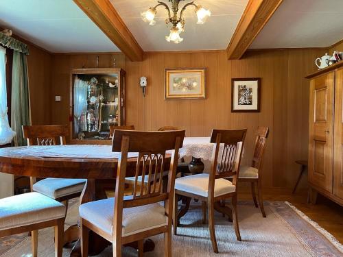 a dining room with a table and chairs at Beatli Chalet in Wildhaus