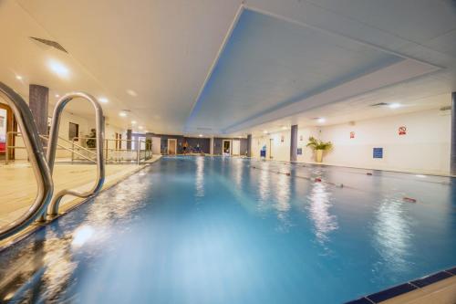 a large swimming pool in a large building at Maldron Hotel & Leisure Centre Limerick in Limerick