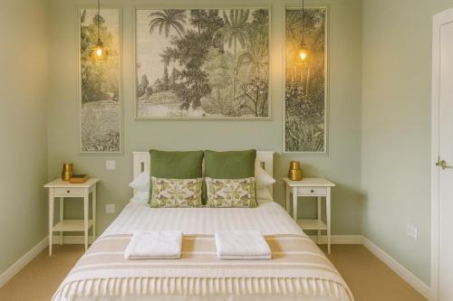 a bedroom with a large bed with two tables at Inbhir Nis City Apartment in Inverness
