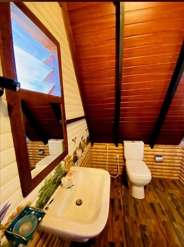 a bathroom with a white sink and a toilet at Senu Lee Cabana in Galle
