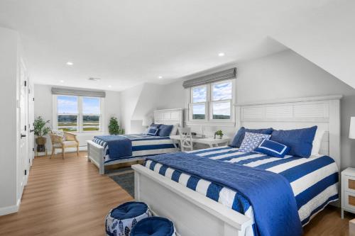 Dos camas en un dormitorio con azul y blanco. en 116 Salt Marsh Road East Sandwich- Ocean's End, en East Sandwich