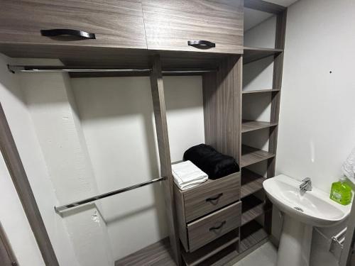 a small bathroom with a sink and a toilet at House 10 minutes from the airport, Rionegro in Rionegro