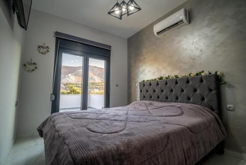 a bedroom with a bed and a window at Luna in Kalymnos