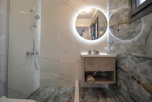 a bathroom with a sink and a mirror at Luna in Kalymnos