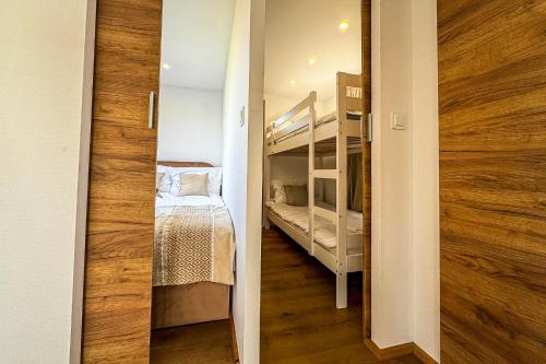 a small room with a bunk bed and a hallway at Houseboat Toruń in Toruń