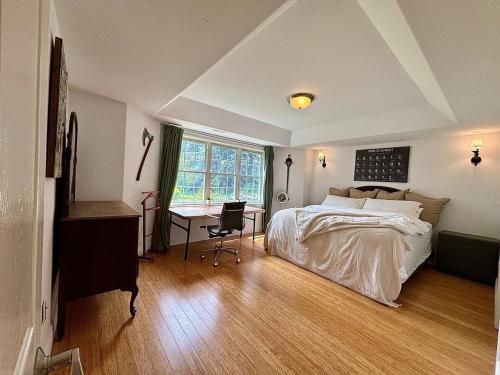 a bedroom with a bed and a desk and a window at Tackle Box Retreat in Deseronto