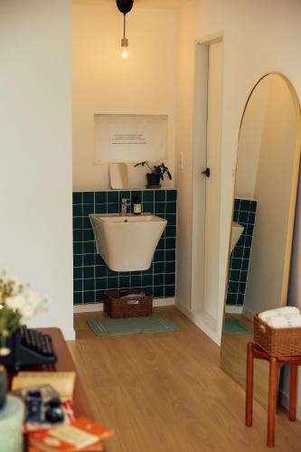 a bathroom with a white sink and a mirror at 사이서가 in Seogwipo