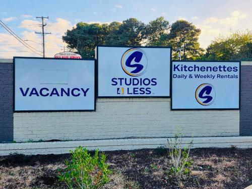 a group of signs on the side of a building at Studios & Suites 4 Less Virginia Beach in Virginia Beach