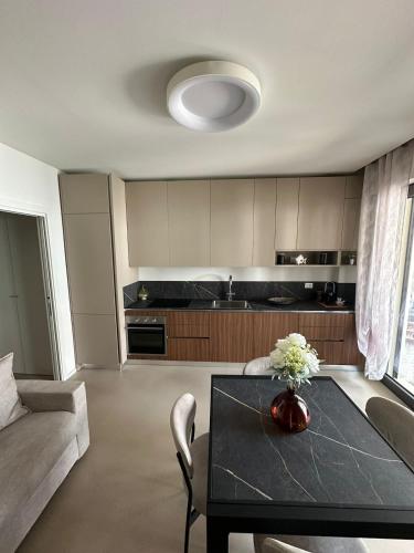 a living room with a table and a kitchen at Colle del Mare in Gabicce Mare