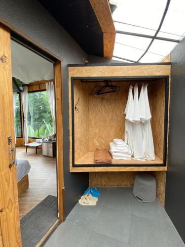 a room with a closet with white towels on it at khaokho keree tara in Khao Kho