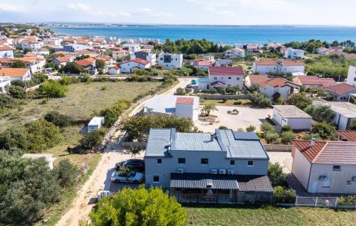 an aerial view of a residential neighborhood with a blue house at Nice Home In Vir With Sauna in Kaštelina