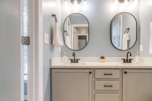 a bathroom with two mirrors and a sink at Home with Pet-Friendly Yard, 1 Mi to Dtwn Raleigh! in Raleigh
