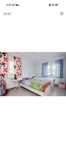 a bedroom with a bed and two windows at Heby in Heby