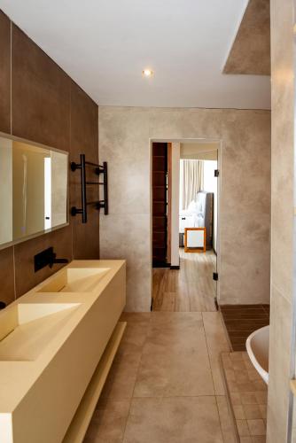 a bathroom with two sinks and a tub at The Pinnacle Polokwane in Polokwane