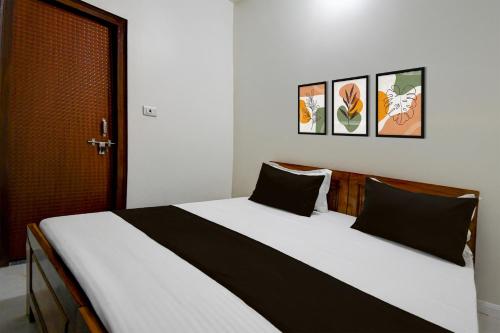 MalhourにあるHotel O Ananta Grandのベッドルーム(白い大型ベッド、黒い枕付)