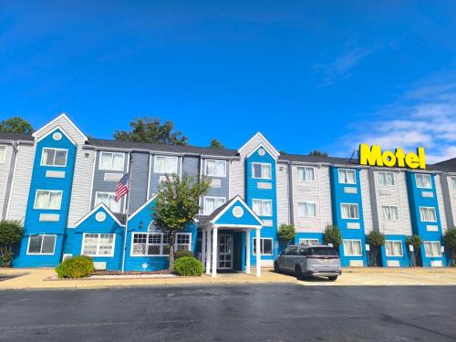 a hotel with a motel sign on the front of it at Budgetel Inn Birmingham in Birmingham