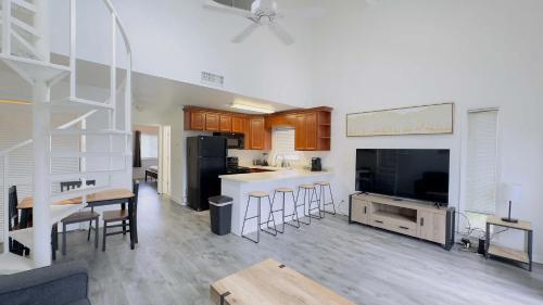 a large living room with a kitchen and a living room with a large television at Lovely 2 bedroom condo with pool J3 in Little River