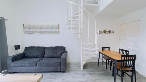 a living room with a couch and a dining room table at Lovely 2 bedroom condo with pool J3 in Little River