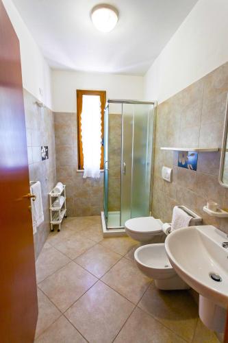 a bathroom with two toilets and a shower at Agriturismo Masseria Terra D'Otranto in Otranto