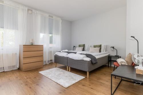 a bedroom with a bed and a dresser in it at Newly Furnished Apartment Kopparberg Train Station in Kopparberg