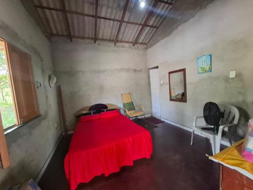 a room with a red blanket on a bed at Casa Brisa do Tapajós in Santarém