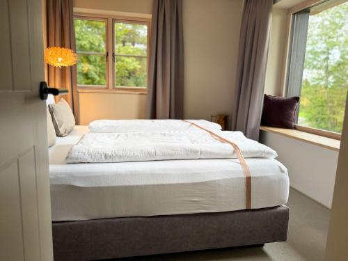 two beds in a room with a window at Das Gretlnest - Premium Naturrefugium in Gamlitz