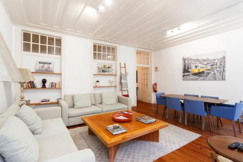 a living room with a white couch and a table at Camões - Bairro Alto - by The Portuguese Story in Lisbon