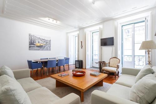 a living room with white furniture and a table at Camões - Bairro Alto - by The Portuguese Story in Lisbon
