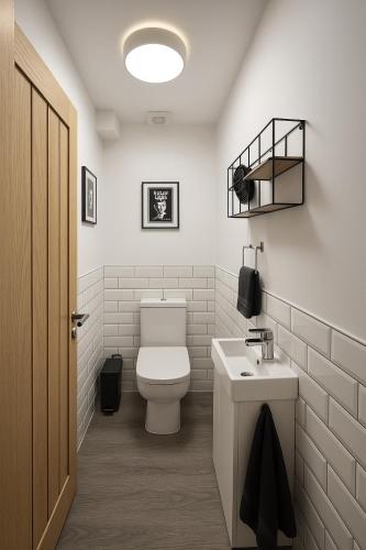 a bathroom with a white toilet and a sink at LT 1 - Studio Apartment - Free Street Parking in Leicester