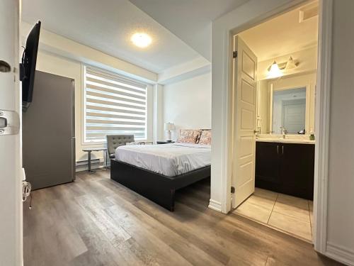 a bedroom with a bed and a desk and a mirror at Keppel Circle Residence in Brampton