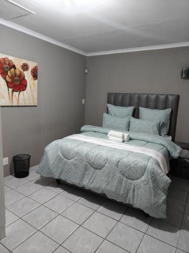 Ένα ή περισσότερα κρεβάτια σε δωμάτιο στο Tranquil Guesthouse