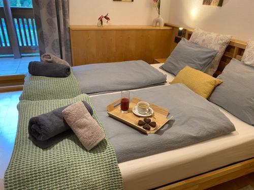 a pair of beds with a tray of food on them at Residenz Maroi - Wasle in Sankt Anton am Arlberg