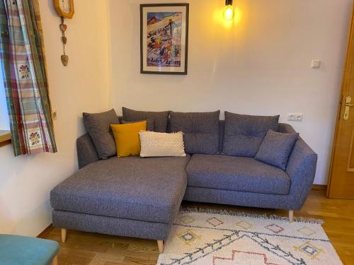 a blue couch with yellow pillows in a living room at Residenz Maroi - Wasle in Sankt Anton am Arlberg
