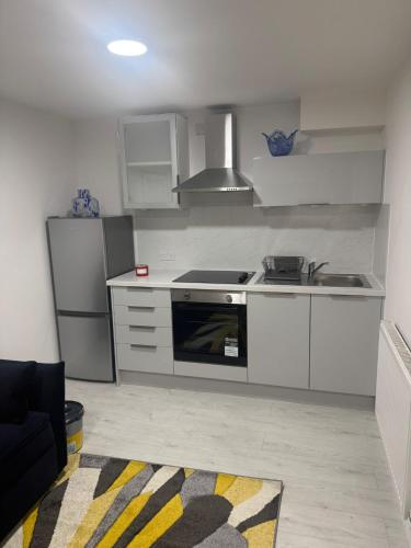 a kitchen with a sink and a stove top oven at Cozy Lodge in Rochester