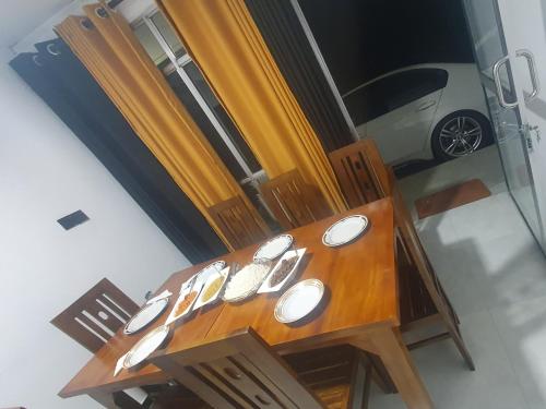 a wooden table with white bowls on top of it at Golden Waters Stay & Dine in Norwood