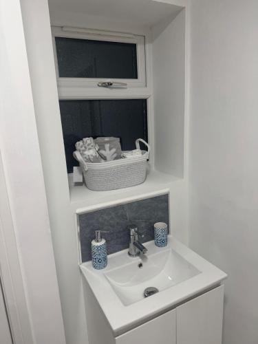 a bathroom with a white sink and a mirror at Cozy Lodge in Rochester