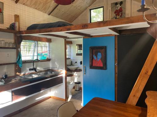 a kitchen with a blue door in a house at Wilhut in Plettenberg Bay