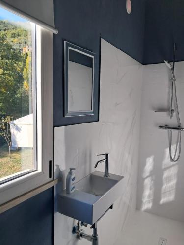 a bathroom with a sink and a window at Gino's House - Locazione Turistica in Gubbio