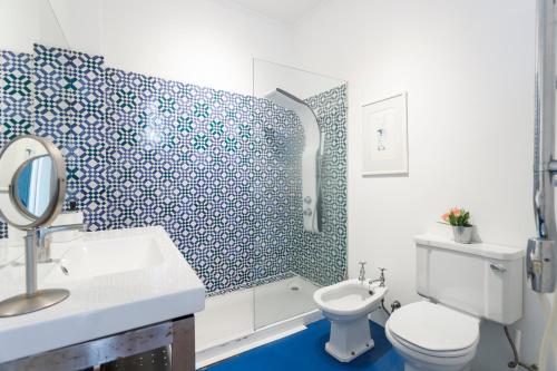 a bathroom with a toilet and a sink and a shower at Camões - Bairro Alto - by The Portuguese Story in Lisbon