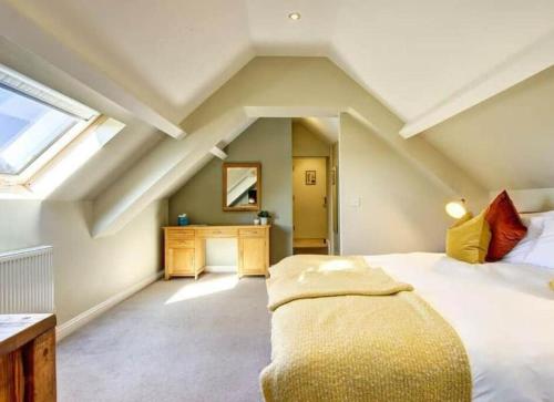 a bedroom with a bed and a desk and a window at Fox Hall in Richmond