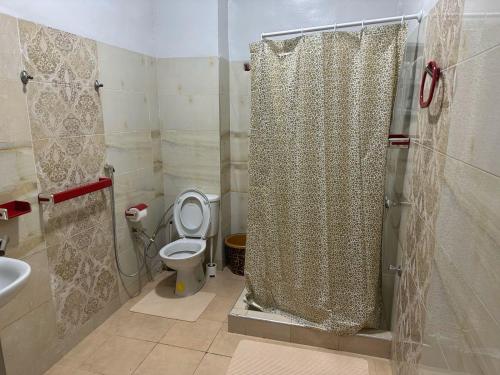 a bathroom with a shower with a toilet and a sink at Location Appartement tangier malabata in Tangier