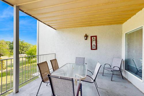 a patio with a table and chairs on a balcony at Water Wheel Resort Condo G202 in New Braunfels