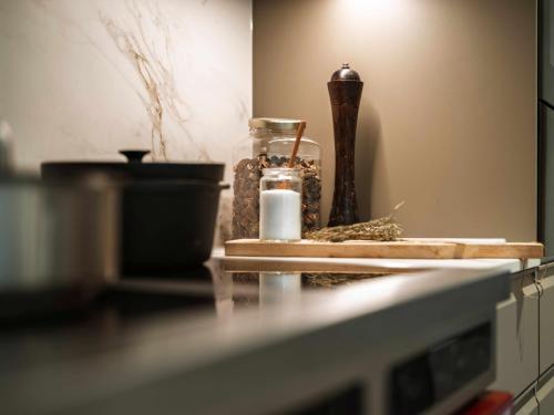 a counter top with a jar of spices and a candle at La Tzoumaz Lodge in La Tzoumaz