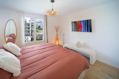 ein Schlafzimmer mit einem großen orangenen Bett und einem Fenster in der Unterkunft Appartement F3 Neuf Vue sur la Seine avec Parking Gratuit Proche Paris Tour Eiffel & Disney in Cormeilles-en-Parisis